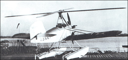 This is the lone Navy XOZ-1, a biplane conversion intended to demonstrate autogiro concepts. Note the four-legged pylon supporting the four-bladed rotor and the absence of a drive shaft to the rotor, which is necessary in a helicopter