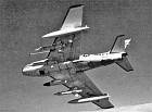 Striking in-flight view of an FJ-4B with three ASM-N-7 Bullpup missiles, missile guidance pod and two drop tanks